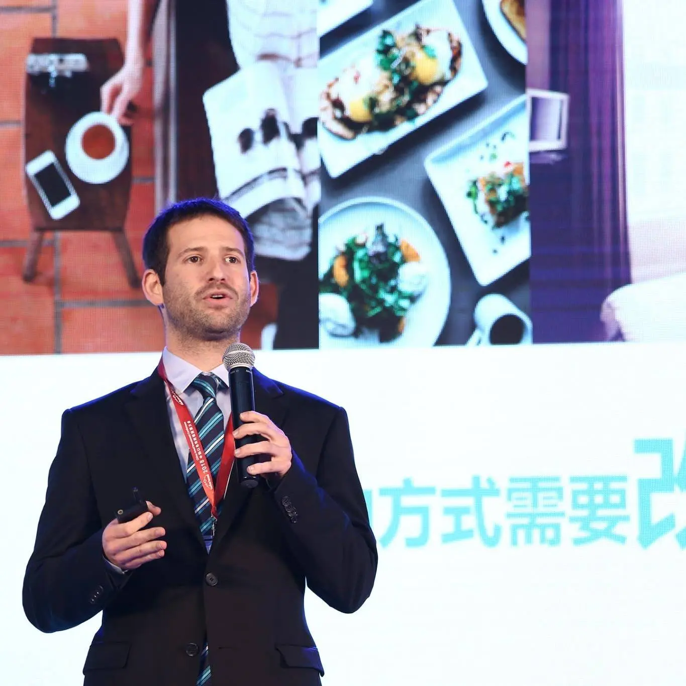 Gal Bareket speaking on an international conference stage